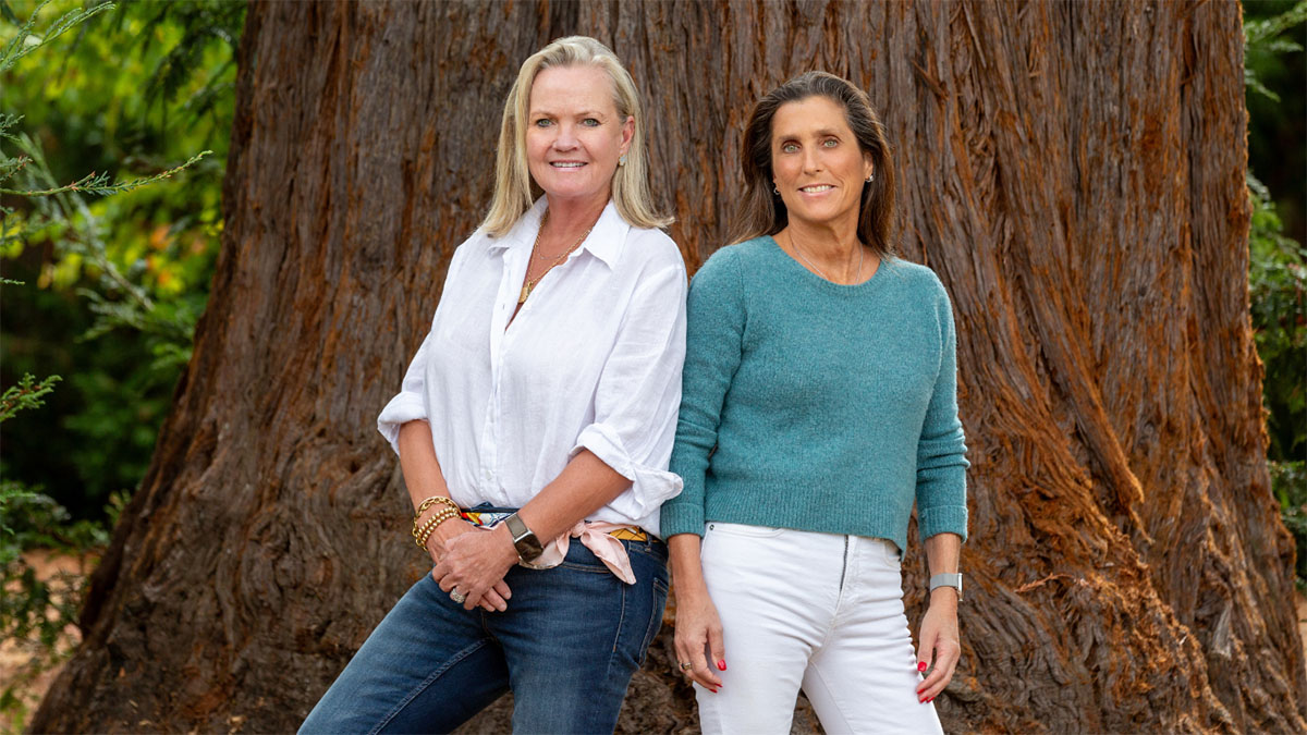 Laura and Kristin standing in front of redwood tree